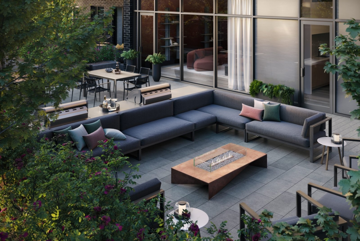 An outdoor patio with couches and a fire pit is perfect for those looking to enjoy the beautiful weather in their new homes.