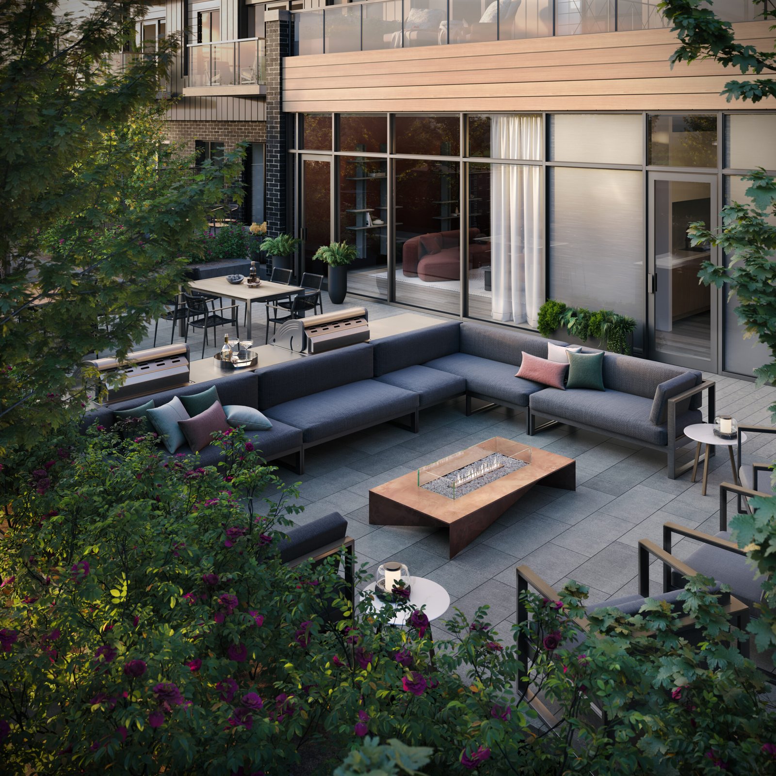 An outdoor patio with couches and a fire pit is perfect for those looking to enjoy the beautiful weather in their new homes.