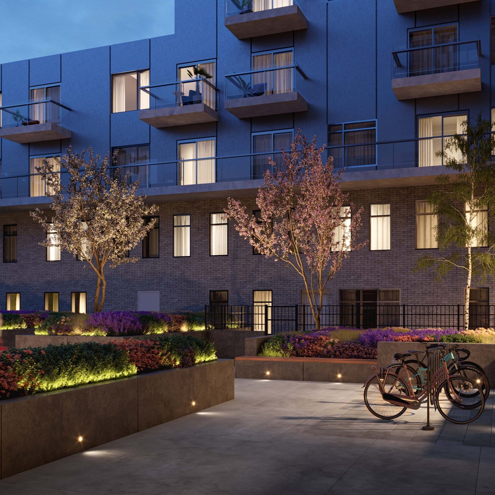 An apartment building with bicycles parked in front of it, showcasing new condos in Gta. An apartment building with bicycles parked in front of it, showcasing new condos in Gta.