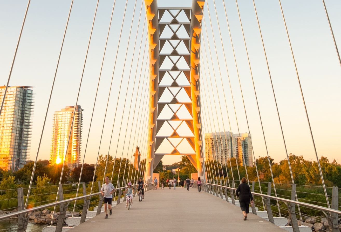 A new bridge over a river with people walking on it. A new bridge over a river with people walking on it.