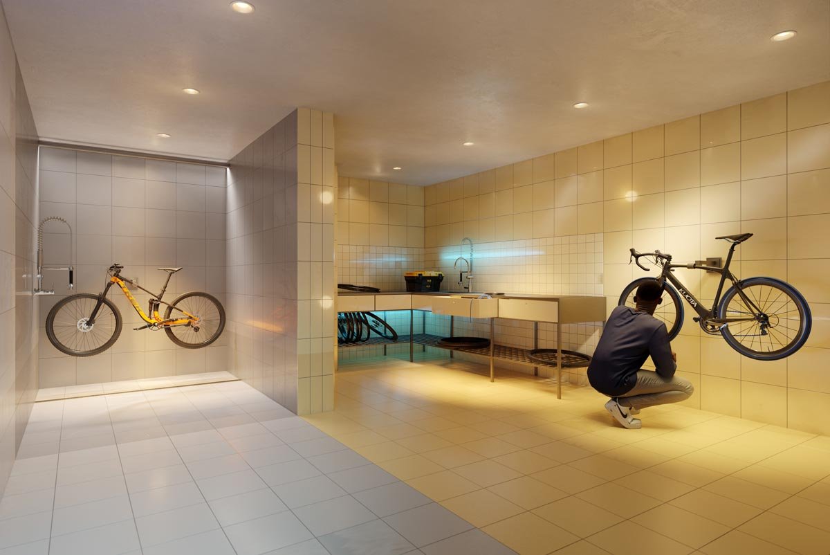 A man is kneeling in front of a new bike in a bathroom. A man is kneeling in front of a new bike in a bathroom.