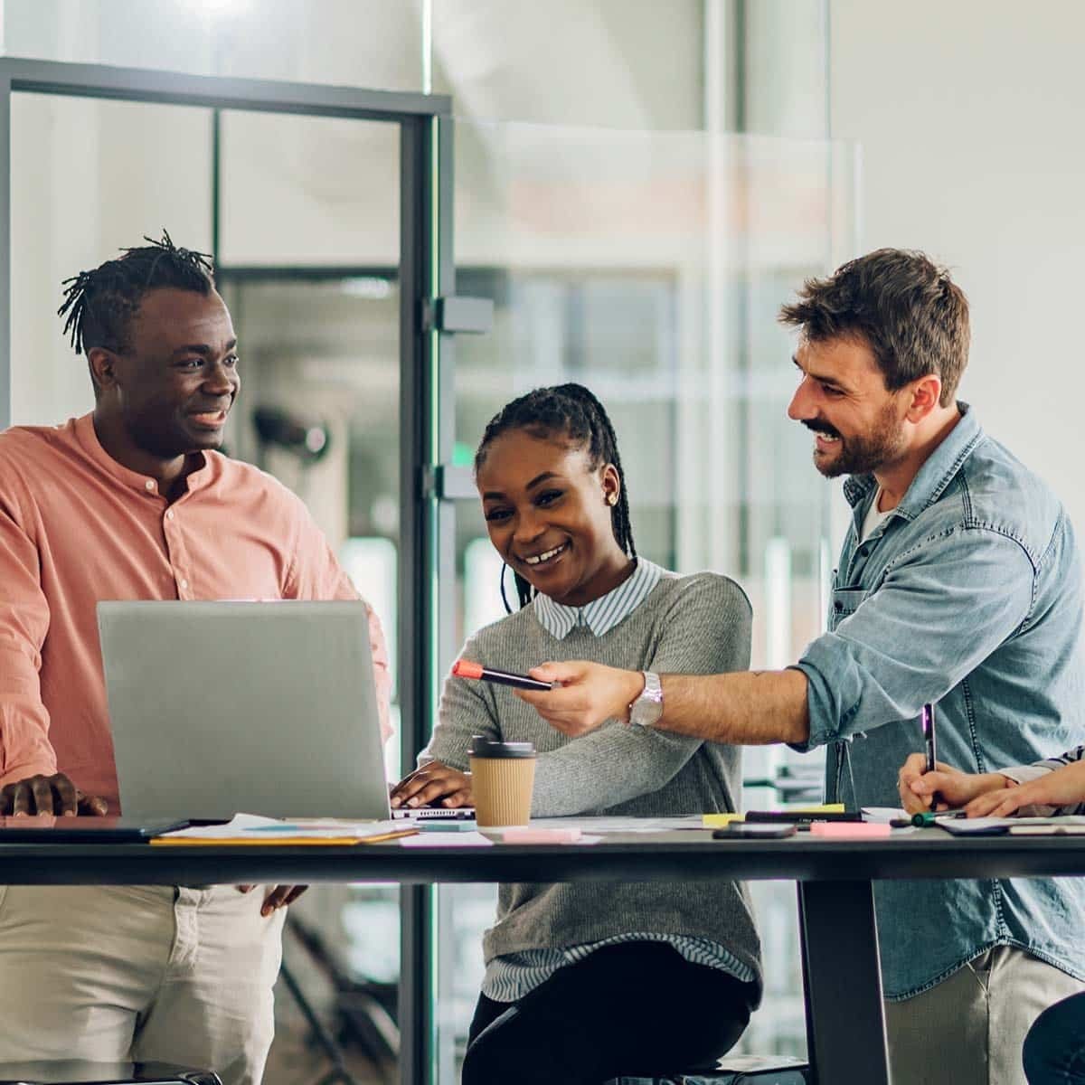 A group of people sitting around a table looking at a laptop, discussing new homes in GTA. A group of people sitting around a table looking at a laptop, discussing new homes in GTA.