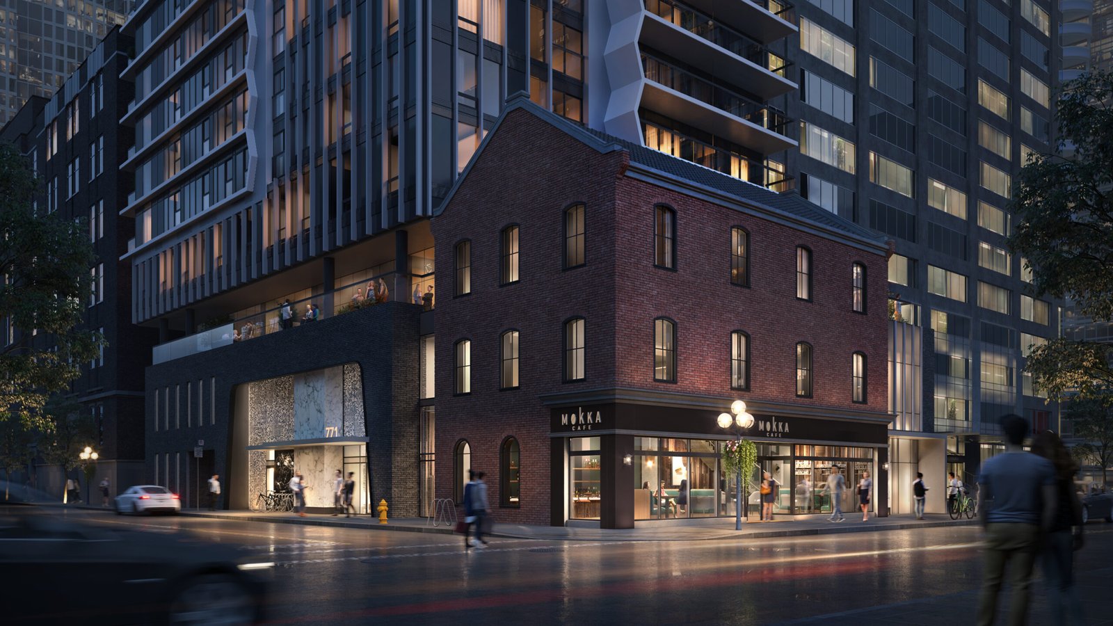 A nighttime city street scene showcases a modern building with a historic brick facade on the corner. The structure, under the glow of illuminated signage, attracts people walking along the wet sidewalk. Nearby modern skyscrapers surround the area, reminiscent of new condos in Brampton.