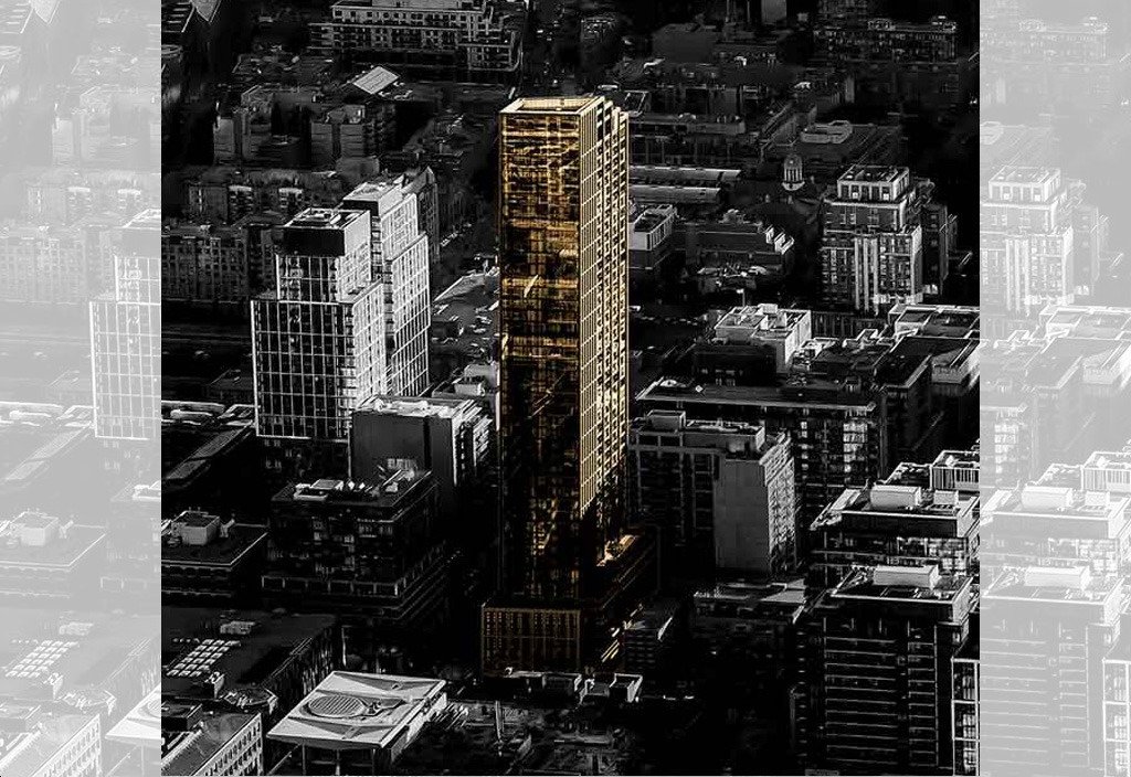 Aerial view of a cityscape at dusk with a prominent golden skyscraper casting long shadows among surrounding buildings. The reflective surface contrasts with the darker tones of the city, while new condos in Brampton rise up on the horizon, enhancing the modern skyline.