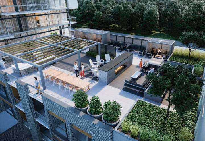 A modern rooftop terrace with a mix of seating areas, including lounge chairs, tables, and a central fireplace graces the view from new homes in GTA. The terrace is surrounded by plants and trees, with a pergola providing partial shade. A few people are seen enjoying the space.