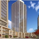 A modern high-rise apartment complex with three buildings of varying heights under a clear blue sky with light clouds stands as a prime example of the new condos in GTA. The complex features glass exteriors and balconies, red foliage trees, a few cars, and people visible at ground level.