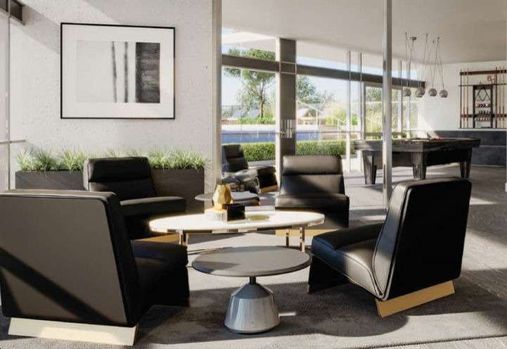 A modern lounge area with four black leather chairs around a round coffee table. Large windows provide natural light, and a pool table is visible in the background. A minimalist black-and-white painting is hung on the wall above a plant arrangement, adding sophistication to new homes in GTA.