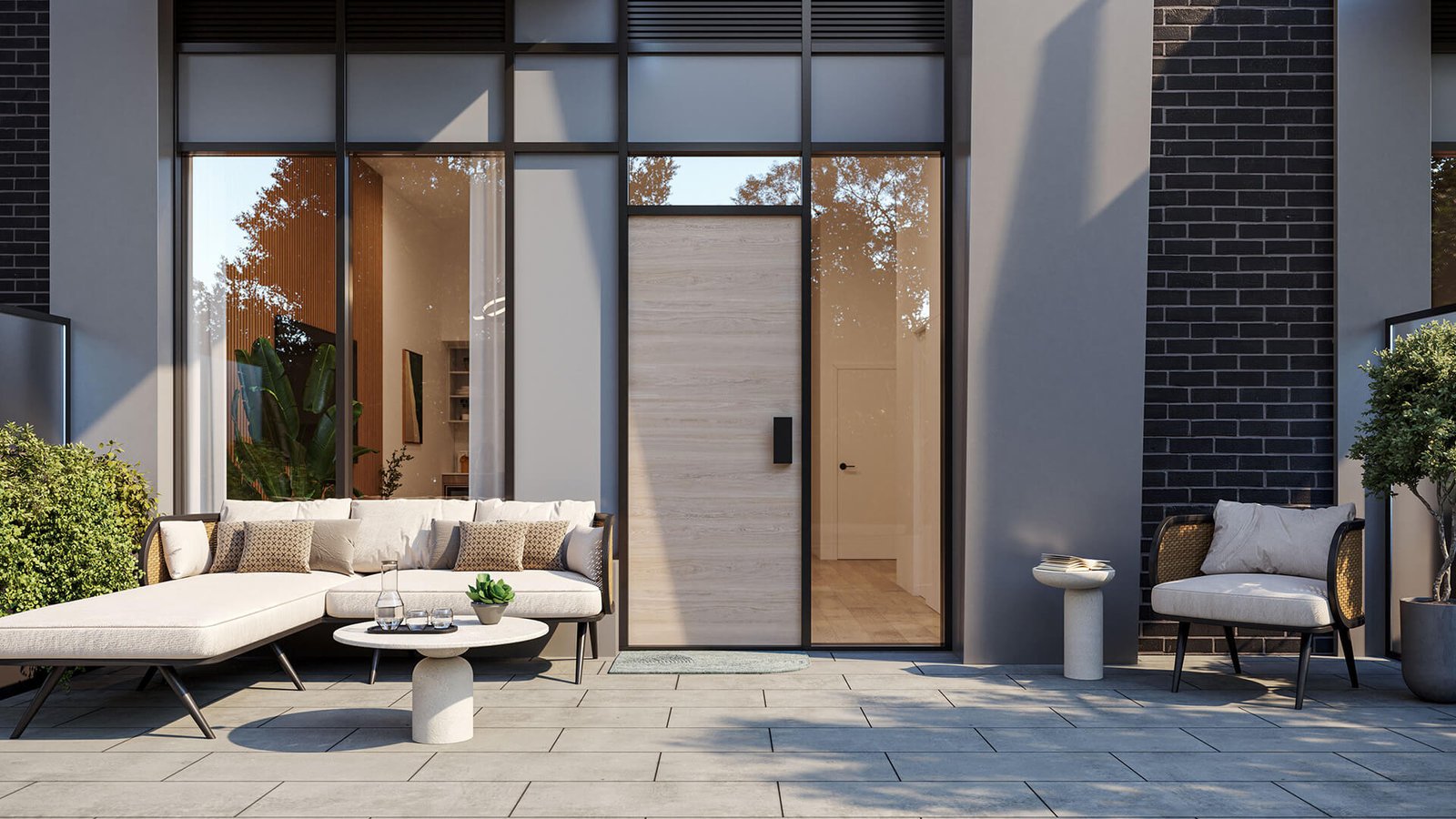 Modern patio with stylish outdoor furniture including a sofa and chairs, complemented by potted plants that add a touch of greenery. Adjacent to tall black-framed windows and a wooden door on a