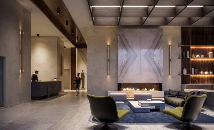 Modern hotel lobby featuring a large central fireplace, sleek sofas, and an elegant wooden bar area, with ambient lighting and a sophisticated architectural design showcasing New homes in Gta.