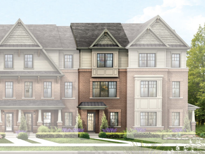 A three-story townhouse with a mix of brick and siding exterior. The building features multiple large windows, gabled roofs, and manicured landscaping with green lawns, small shrubs, and purple flowering plants. This exquisite residence is among the new homes in GTA's most sought-after neighborhoods.