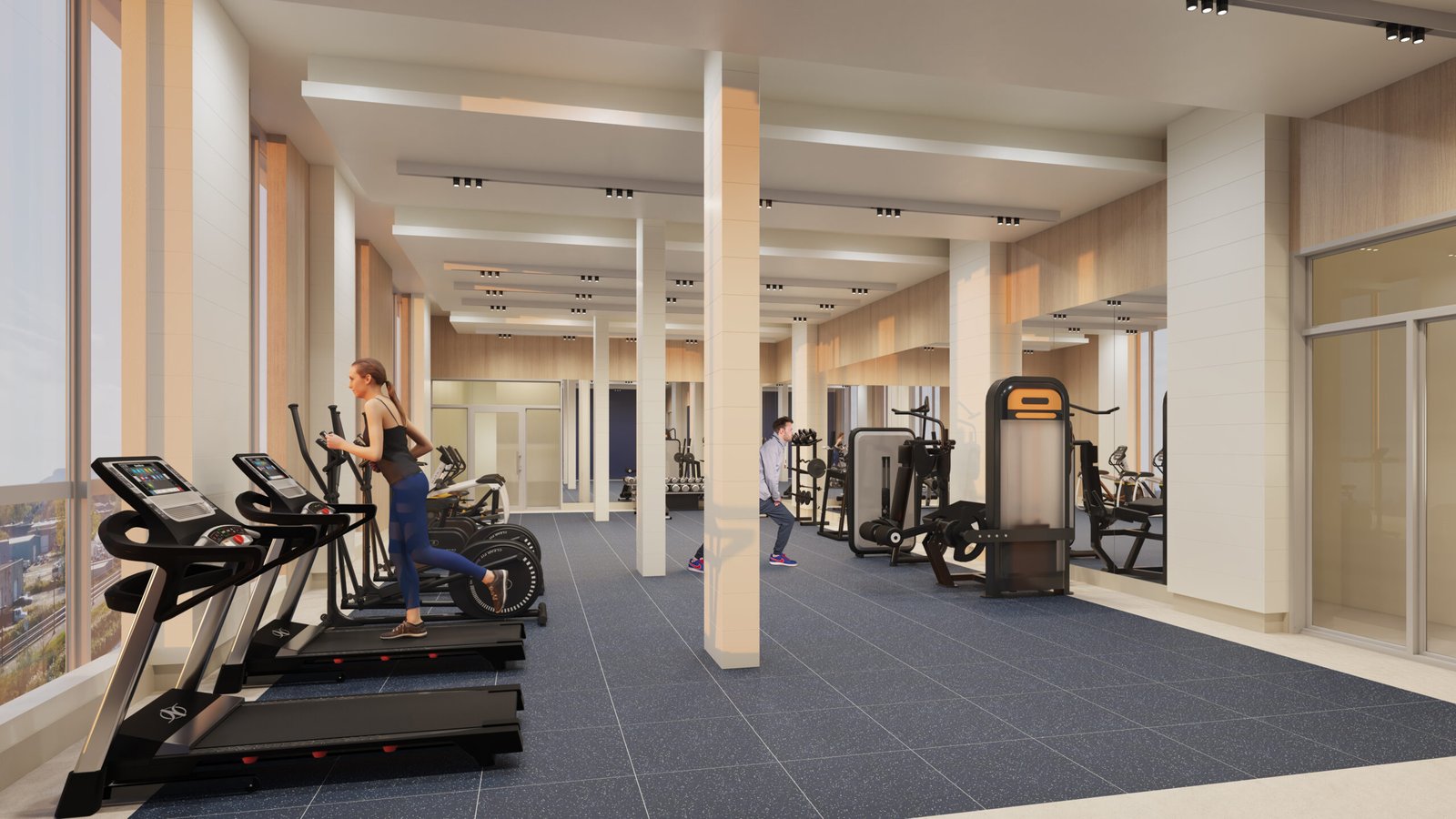 A modern gym in one of the new homes in GTA, featuring large windows, a blue-tiled floor, and beige walls. Three treadmills are in the foreground, one occupied by a woman running. Further back, a man is using weights. Various other workout machines are visible throughout the space.