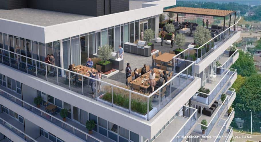 Artist's concept of a modern apartment building's outdoor terrace in new homes in GTA. It features people dining and socializing at tables and standing by the railing. The terrace is furnished with greenery, potted plants, and a pergola-covered seating area, offering scenic city views.