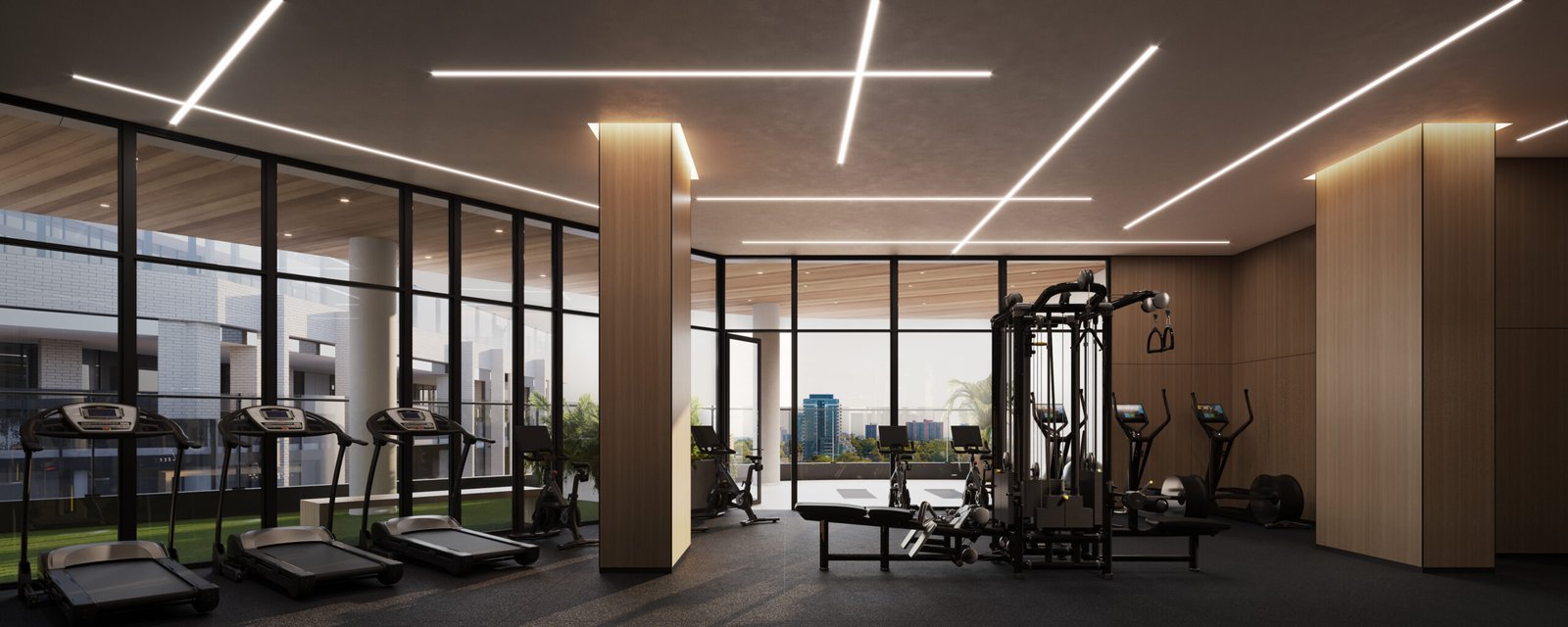 A gym room in a pre-construction building with a view of the city. A gym room in a pre-construction building with a view of the city.
