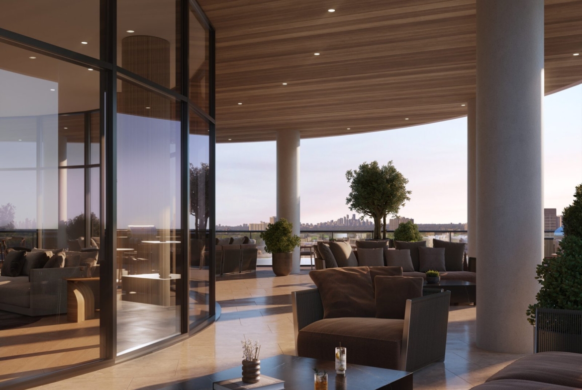 A modern, luxurious outdoor terrace with a wooden ceiling has comfortable seating, potted plants, and glass walls. The sun is setting, casting a warm glow over the scene. Two beverages from LSQ 2 sit on a low table, with distant cityscape views in the background.