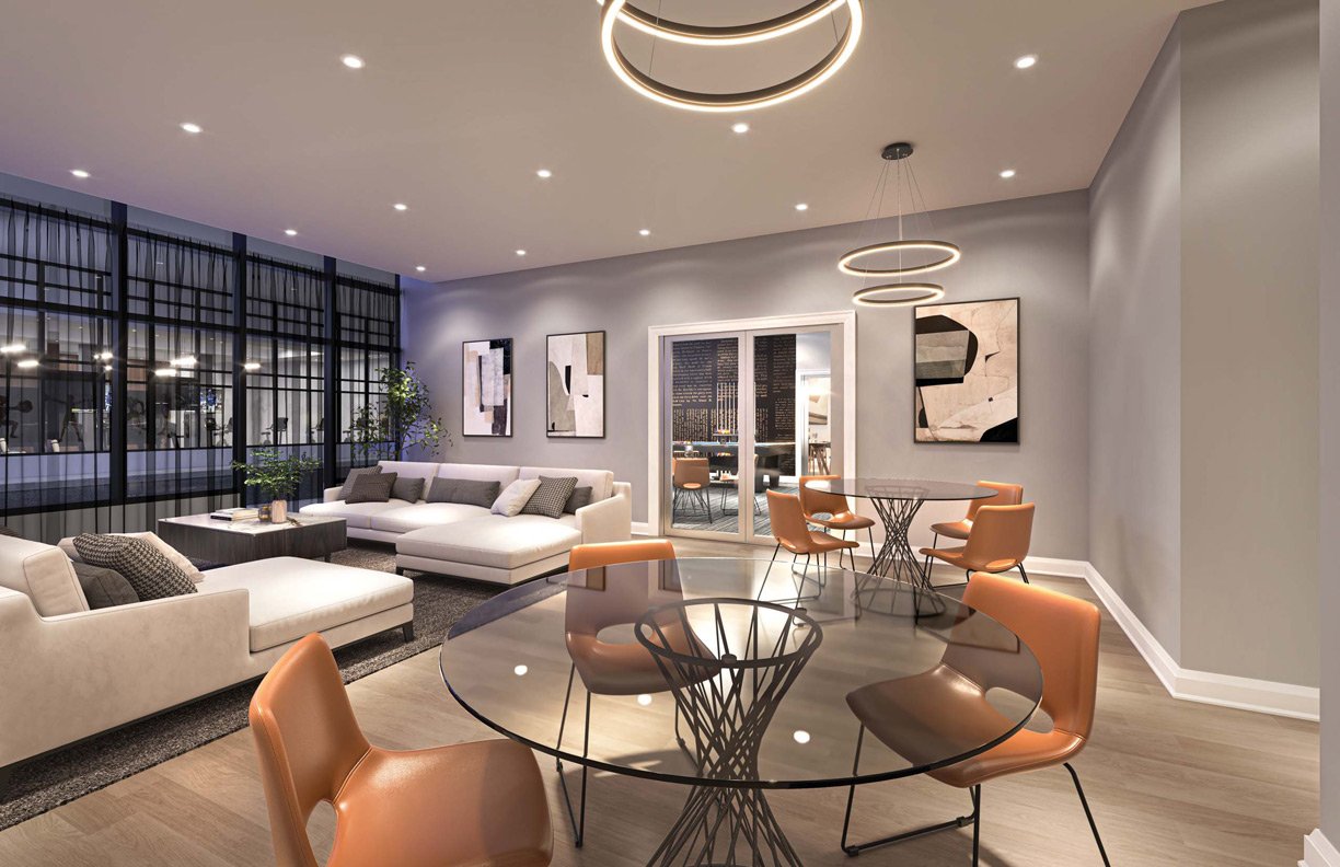 A modern apartment living area with a lounge section featuring a gray sofa, a dining area with a round glass table and orange chairs, and stylish circular ceiling lights. Large windows provide a city view.