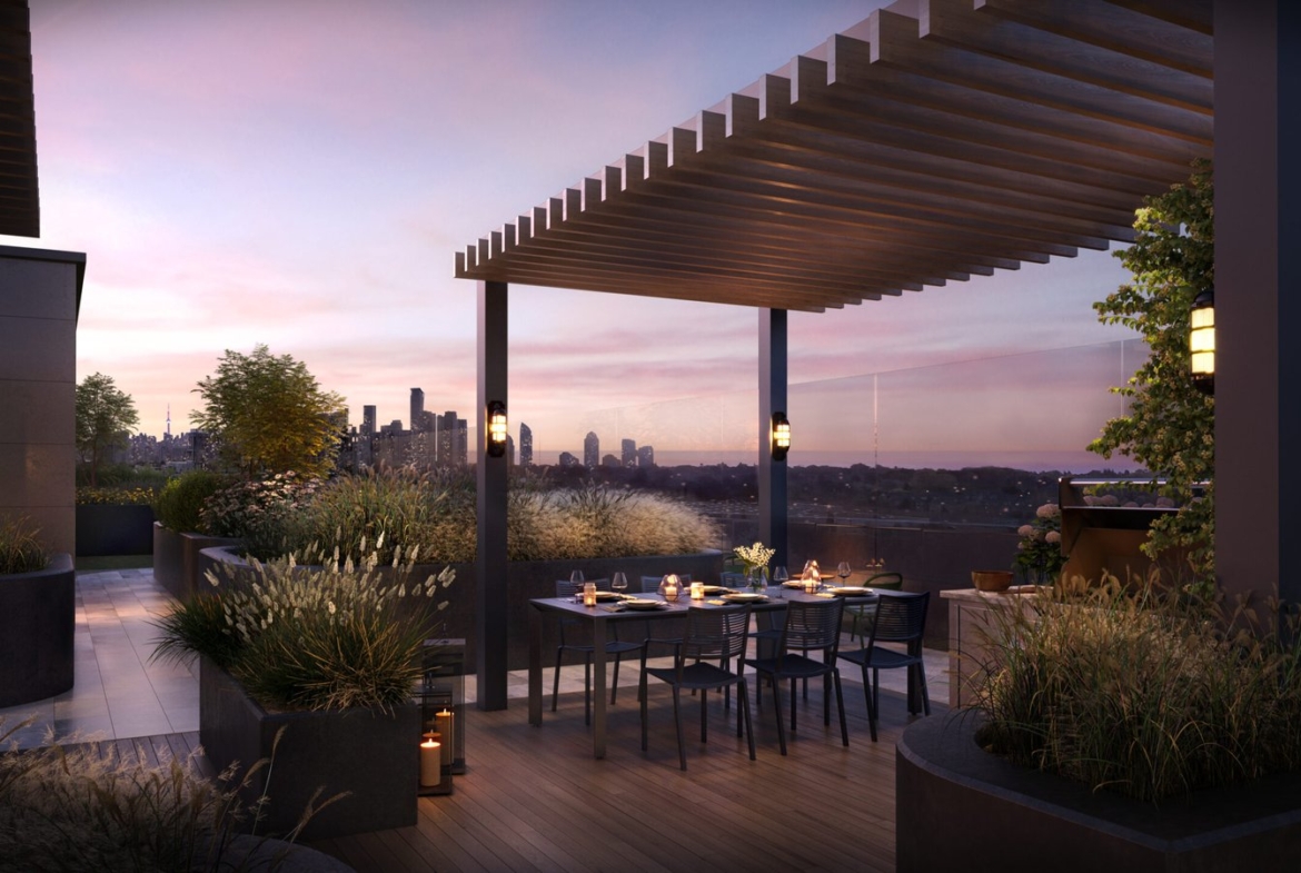 A rooftop terrace at twilight featuring an elegant dining area set for a meal, surrounded by lush planters and city skyline views under a wooden pergola, offered by Gagan Bector.