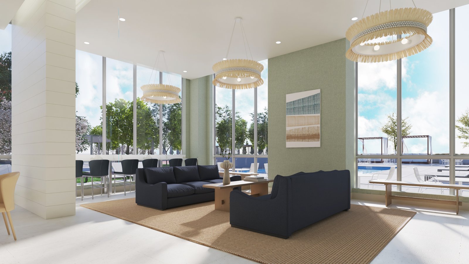 A modern lounge area in one of the stunning new homes in GTA features large windows revealing a pool outside. Inside, two dark blue sofas sit on a beige rug with a wooden coffee table between them, and three contemporary chandeliers hang from the ceiling. Bar stools line a counter near the windows.