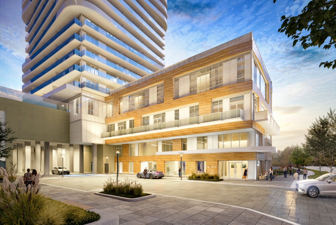 An elegant, modern building complex with a sleek white tower featuring curved balconies and a shorter, brick-patterned adjacent building. The foreground showcases a clean, spacious plaza with landscaped greenery and some people and cars scattered about—an enticing option for new condos in GTA.