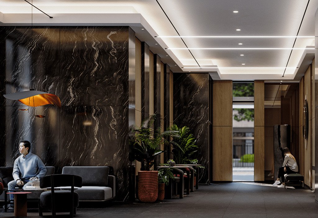 A modern lobby with marble walls and sleek lighting showcases the luxury of new homes. Two people are seated on separate sofas; one is reading, the other using a phone. Indoor plants adorn the space, while large windows offer a view of trees outside.