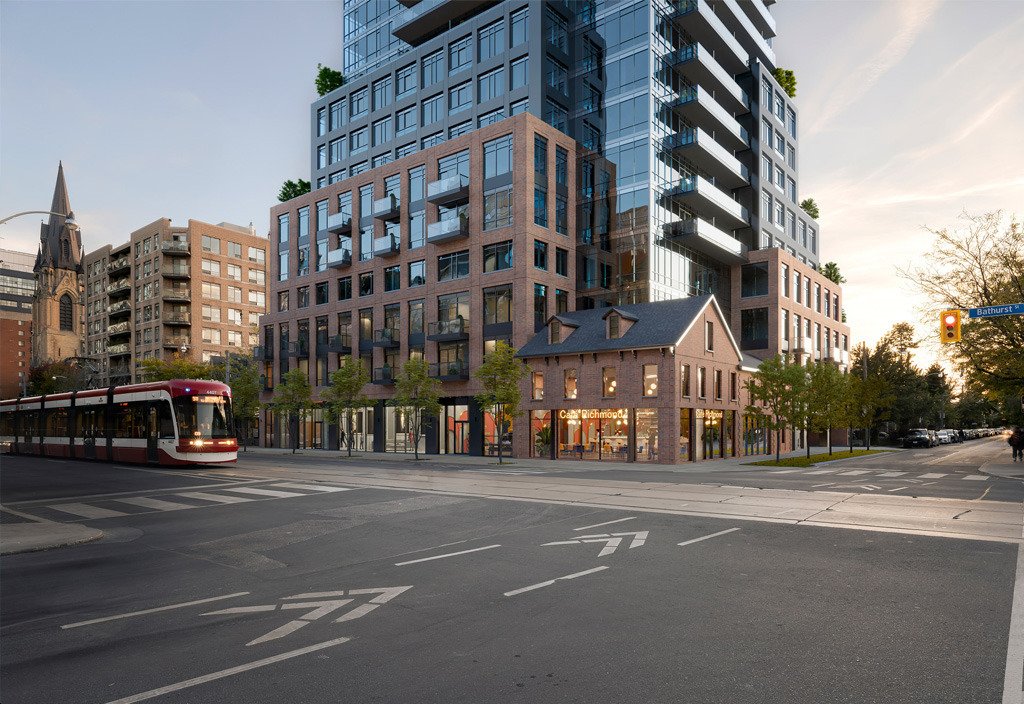 A street corner showcases a modern multi-story building with glass and brick, complemented by an old-style brick house hosting a café. A red tram passes to the left, while trees line the sidewalk in this vibrant urban scene. Nearby, new condos in Brampton catch the eye among classic architecture.