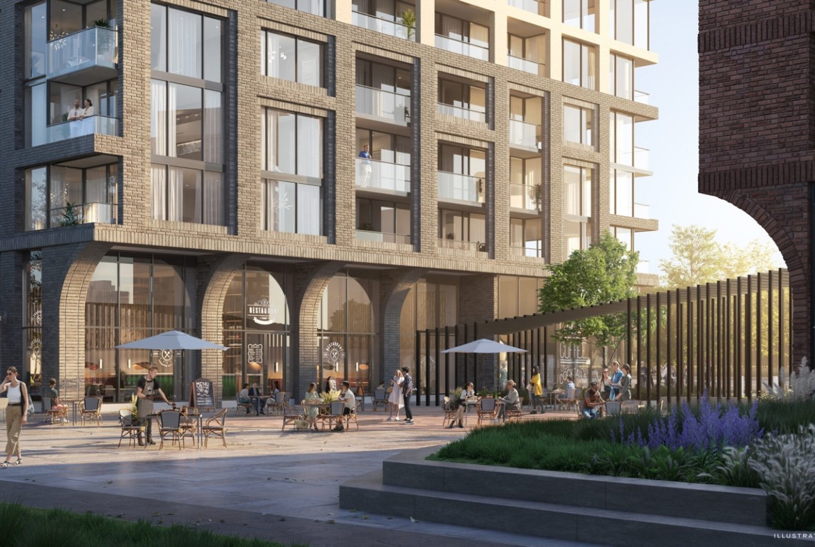 A vibrant street scene at the base of a modern apartment building featuring outdoor café seating, pedestrians, dogs, and lush greenery on a sunny day with new condos.