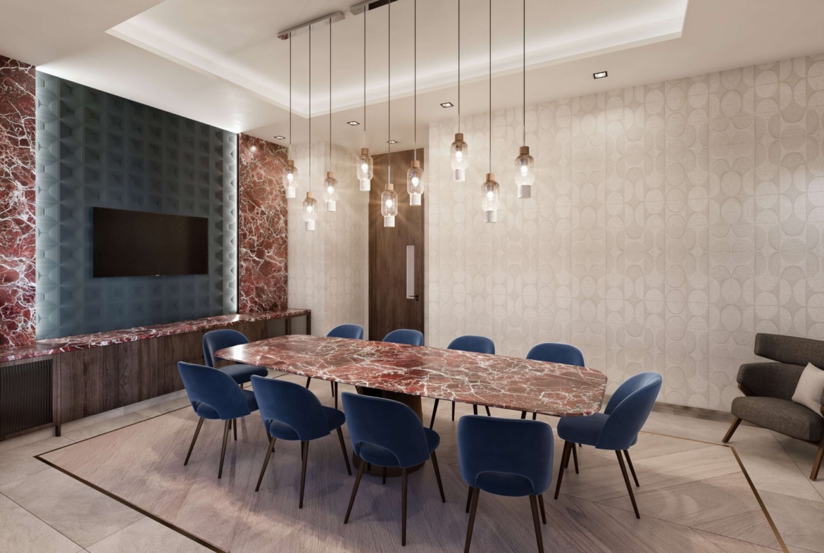 A modern conference room features a large marble table surrounded by blue chairs, with a row of pendant lights above. The walls showcase geometric patterns and red marble, while a flat-screen TV is mounted on one wall—an inspiring space for discussing new homes in Toronto.
