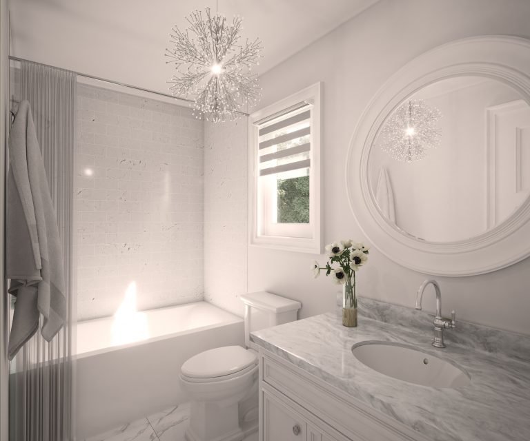 A bright, modern bathroom in one of the new homes features a marble countertop sink, a round mirror, a toilet, and a bathtub. A chandelier-style light fixture hangs above, and the window has a striped blind. A small vase with flowers graces the counter.