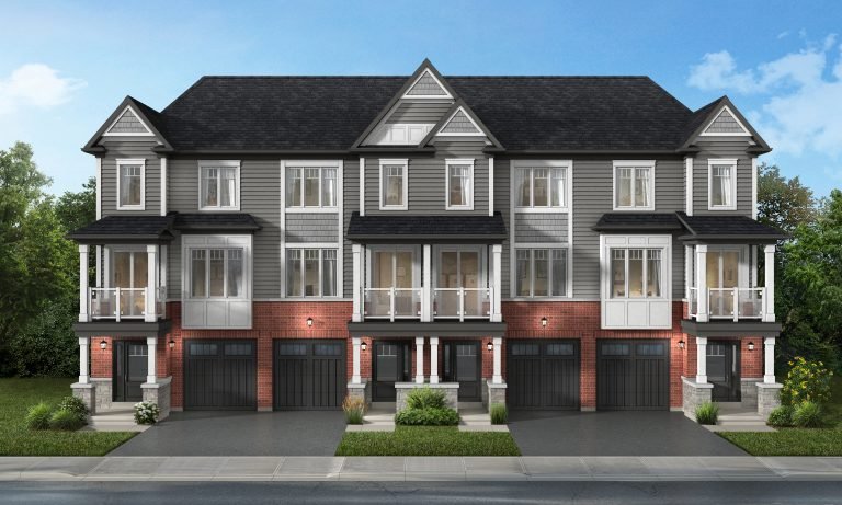 A row of three modern townhouses with gray siding and red brick exteriors, featuring large windows and balconies. Each house has an attached garage and neatly landscaped surroundings under a clear blue sky, showcasing the allure of new homes in GTA.