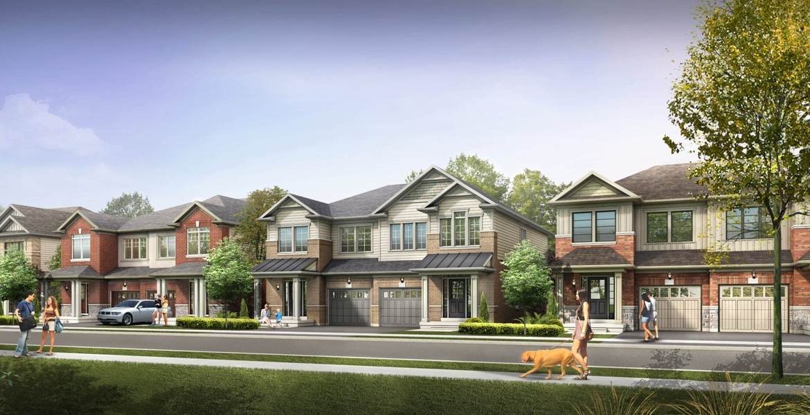 A row of suburban houses with varying architectural styles lines a tree-filled street. People stroll the sidewalk, and a dog is being walked. Cars are parked in driveways and on the street under a clear blue sky, complementing the new homes in Brampton.