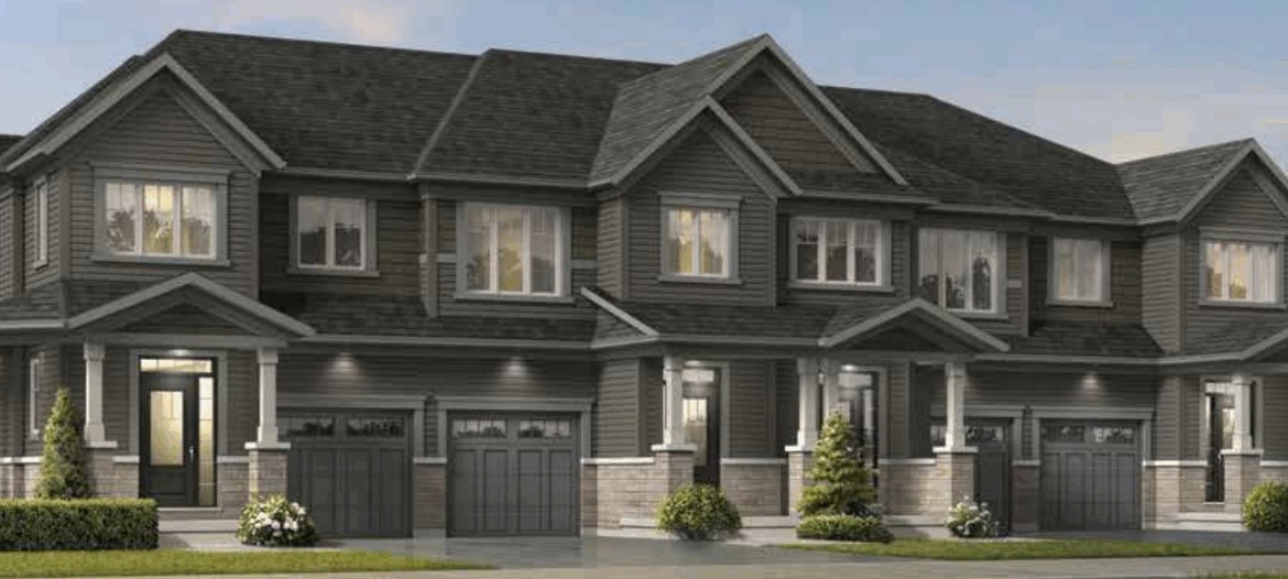 A row of new homes in Brampton features modern townhouses with dark gray siding, multiple windows, and attached garages. These stylish residences are surrounded by small shrubs and a neatly maintained lawn.