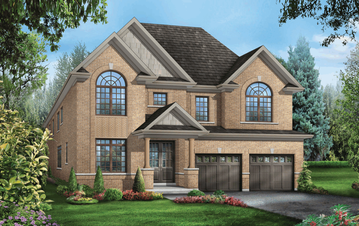 A two-story brick house with large arched windows, a dark shingled roof, and two garage doors. This pre-construction home is surrounded by a well-maintained garden with shrubs and colorful flowers, set against a backdrop of trees and blue sky.