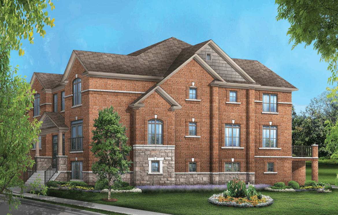 A spacious two-story brick house with multiple gables and windows stands against a blue sky. The front yard showcases well-maintained greenery and a flower bed, while trees frame the scene. Ideal for those exploring new homes, this property exudes charm and comfort.