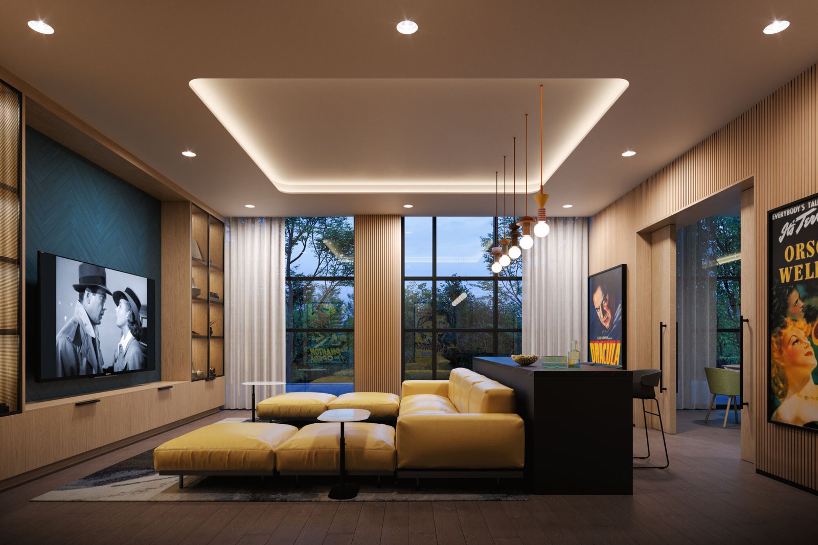 A modern living room in Mile & Creek 3 Condos features a large yellow sectional sofa, surrounded by black-and-white movie posters and a flat-screen TV showcasing a classic film. Large windows overlook lush trees, while pendant lights elegantly illuminate the cozy Mile Creek seating area.
