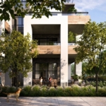A modern condo building, Mile & Creek, boasts large balconies enveloped by lush trees and greenery. Two people relax on a balcony while another walks their dog on the sunlit sidewalk, creating a blissful scene.
