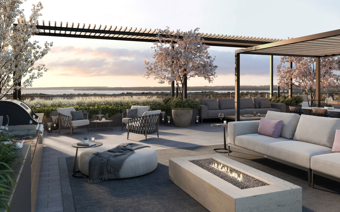 A modern rooftop patio in one of the new homes in Toronto features comfortable seating around a rectangular fire pit. Blossoming trees and potted plants decorate the space. The setting sun casts a warm glow over the relaxed ambiance, with a view of nature in the background. A modern rooftop patio in one of the new homes in Toronto features comfortable seating around a rectangular fire pit. Blossoming trees and potted plants decorate the space. The setting sun casts a warm glow over the relaxed ambiance, with a view of nature in the background.