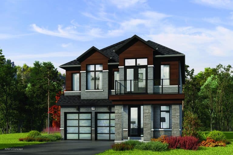 Located in the Oakridge community, this modern two-story house boasts a blend of stone and wood siding. With its large windows, balcony, and double garage, the home exemplifies Green Homes living amid a lush green lawn and trees beneath a clear blue sky.