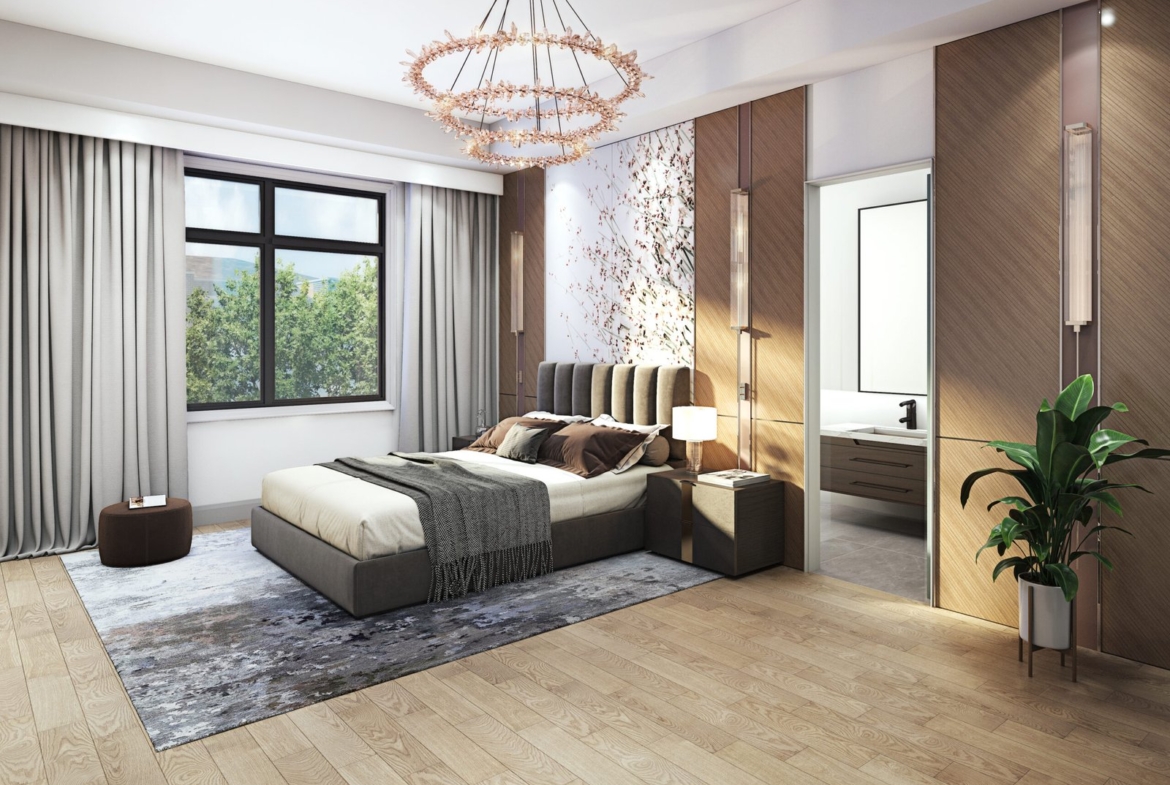 A spacious bedroom with a modern design features a large bed, patterned rug, and leafy plant. Neutral-colored walls complement the large window with curtains, while a contemporary chandelier adds elegance. An open door reveals a glimpse of the bathroom. Ideal for those seeking new homes in GTA.