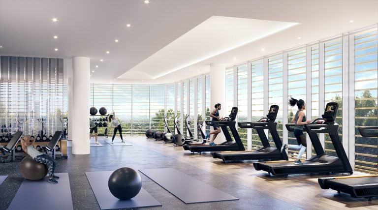 A modern gym at Park Place, with large windows and natural light. People are using treadmills and exercising on yoga mats. Exercise balls and fitness equipment are visible in this spacious, clean space, perfectly complementing the contemporary vibe of VMC Condos.