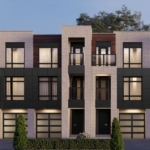 Nestled in the charming Ravine Towns, this modern three-story building with a flat roof showcases large windows and dark panels against light brickwork. Two entrances invite you in, flanked by small shrubs. A clear sky and partial trees complete the picturesque setting.