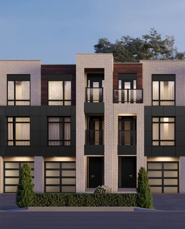 Nestled in the charming Ravine Towns, this modern three-story building with a flat roof showcases large windows and dark panels against light brickwork. Two entrances invite you in, flanked by small shrubs. A clear sky and partial trees complete the picturesque setting.