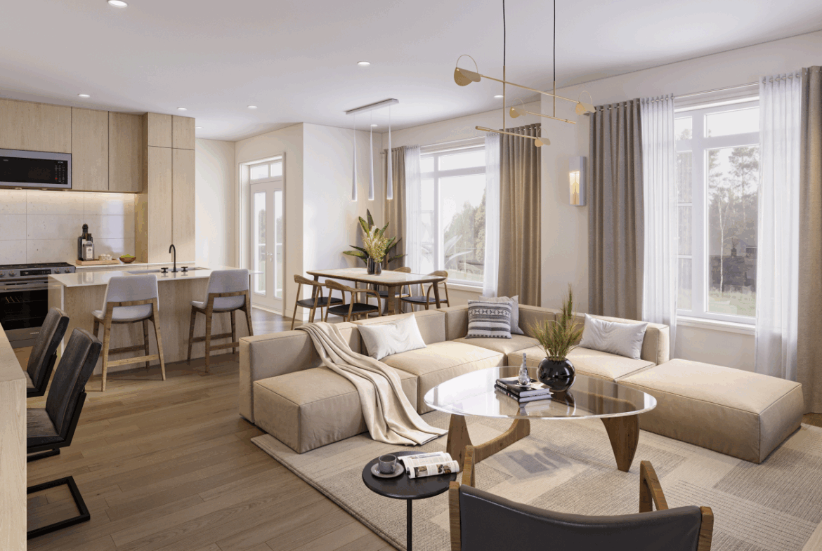 Explore this modern open-concept living room and kitchen area in new homes in Brampton, featuring light wooden flooring and neutral furnishings. A large sectional sofa complements the round glass coffee table, while natural light streams in through expansive windows with elegant curtains.