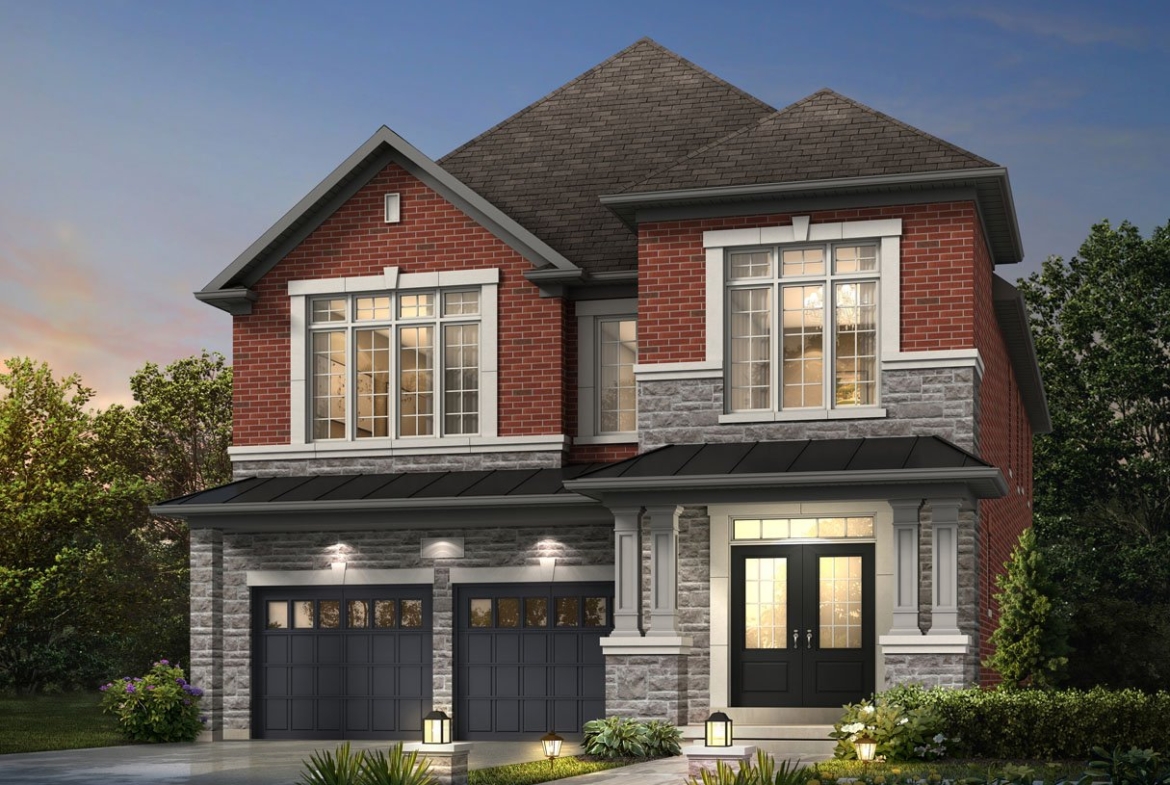 A two-story house with a red brick and gray stone exterior features two garage doors, large windows, and a welcoming porch. The landscaped front yard is adorned with shrubs and lit by small pathway lights. Perfect for those seeking new homes in Brampton, the setting is beautifully captured at dusk.