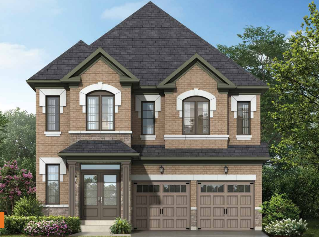 A two-story brick house in Brampton with a dark gray roof features a double garage with brown doors. The facade includes white trim around the windows and is surrounded by greenery and flowering shrubs, all under a clear blue sky. It's an appealing example amidst new homes in the area.