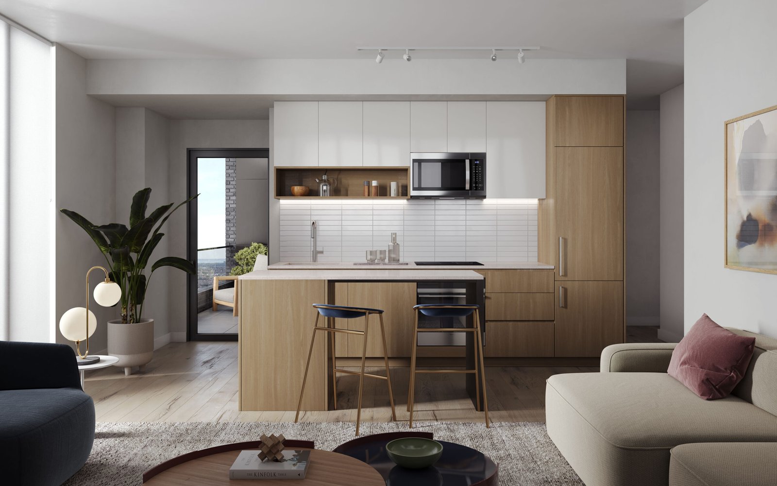 Modern kitchen with light wood cabinets and a white tile backsplash, set in one of the chic condos. Features include a central island with two bar stools and a potted plant near the glass door leading to a balcony. The cozy living area boasts a beige sofa and abstract art on the wall.