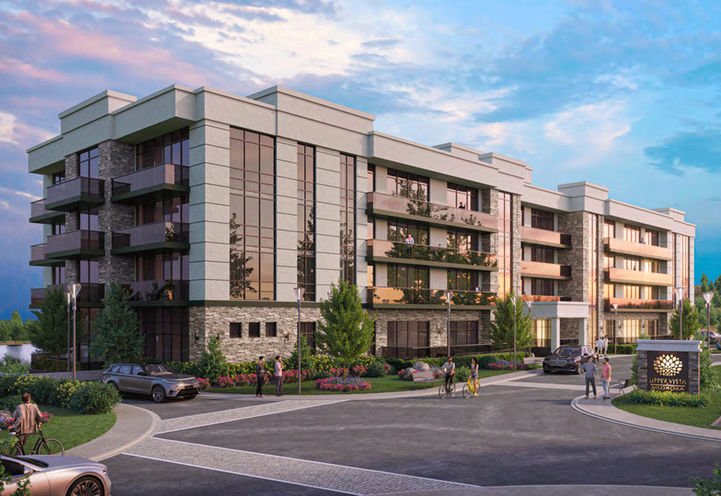 A modern four-story apartment building with large windows, balconies, and surrounding greenery stands proudly as Muskoka Condos. People are walking and cars are parked in the front driveway. The sky is partly cloudy with a hint of blue. A sign with "Upper Vista Muskoka" is visible near the entrance.