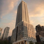 101 Spadina Condos A tall, modern skyscraper with a sleek design stands prominently against a sunset sky, part of the Toronto Real Estate landscape. The building's facade features large windows and geometric patterns. Nearby, other high-rise buildings are visible, and trees are in the foreground.