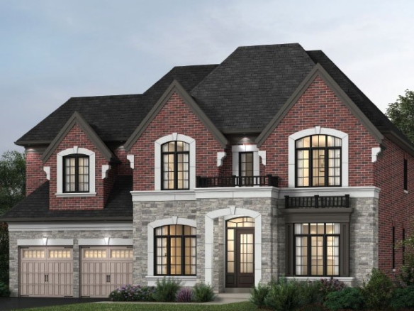 A two-story brick and stone house by Gagan Bector featuring a dark roof. It has arched windows, two garage doors on the left, and a small balcony on the upper right. The surrounding landscape includes bushes and trees, beautifully illuminated with outdoor lighting.