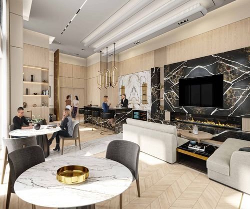 A modern lounge with stone tables, marble-paneled walls, and a large TV above a sleek fireplace welcomes guests in this chic new condo in GTA. People are seated and standing, engaged in conversation. The room features neutral tones, pendant lighting, and floor-to-ceiling windows.