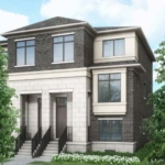 Camden Crossing A modern two-story house in Camden Crossing with brick and stone exterior walls, large windows, and a gabled roof. The front entrance features double doors accessible by two sets of stairs with metal railings, and the house is surrounded by small shrubs and greenery.