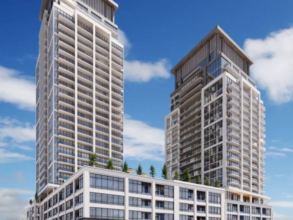Two modern high-rise buildings with glass facades stand under a clear blue sky. These new condos share a podium featuring commercial spaces and rooftop greenery. In the foreground, an empty street and parking lot await future residents seeking new homes in the GTA.